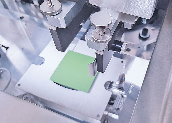 Interior view of a printing system with a green square in the center.