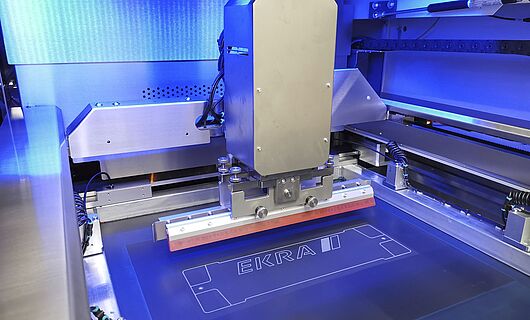 Interior view of a screen printing machine. Squeegee on a surface.
