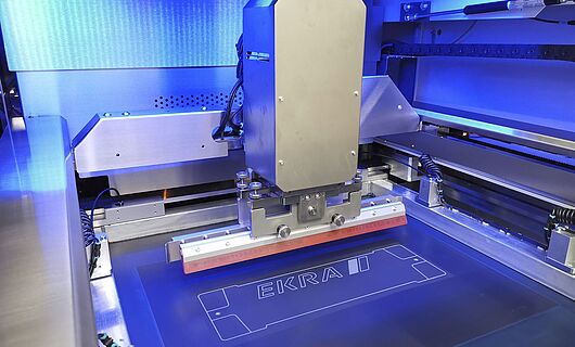 Interior view of a screen printing machine. Squeegee on a surface.
