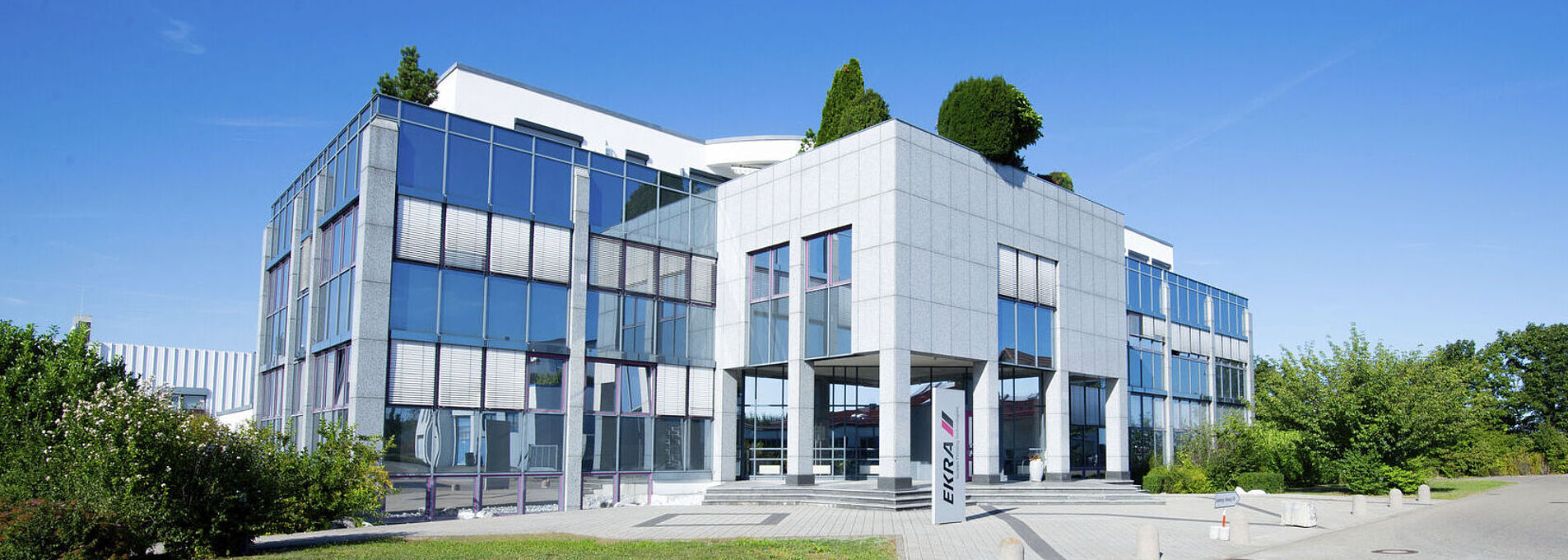 Exterior view of a building from the side with a glass facade.