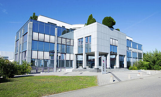 Exterior view of a building from the side with a glass facade.