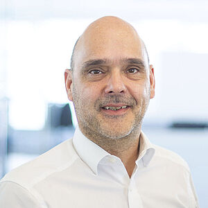Smiling man in a white shirt.