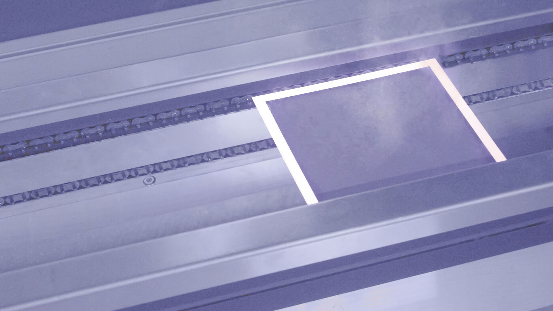 Plate during the laser drying process, emitting vapor.