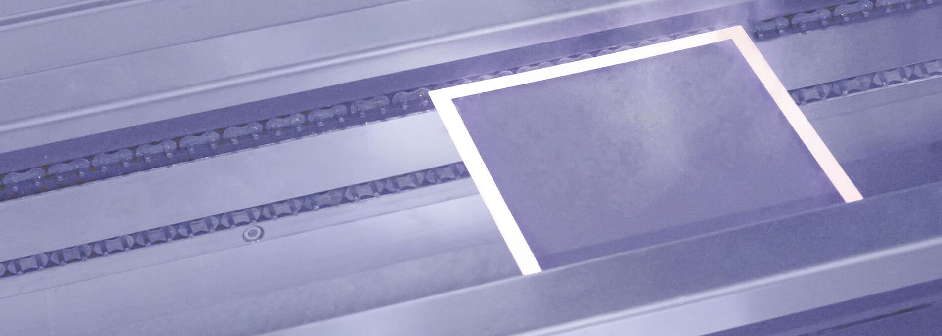Plate during the laser drying process, emitting vapor.
