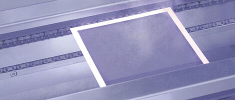 Plate during the laser drying process, emitting vapor.