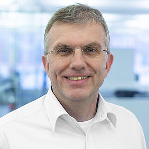 Smiling man in a white shirt.