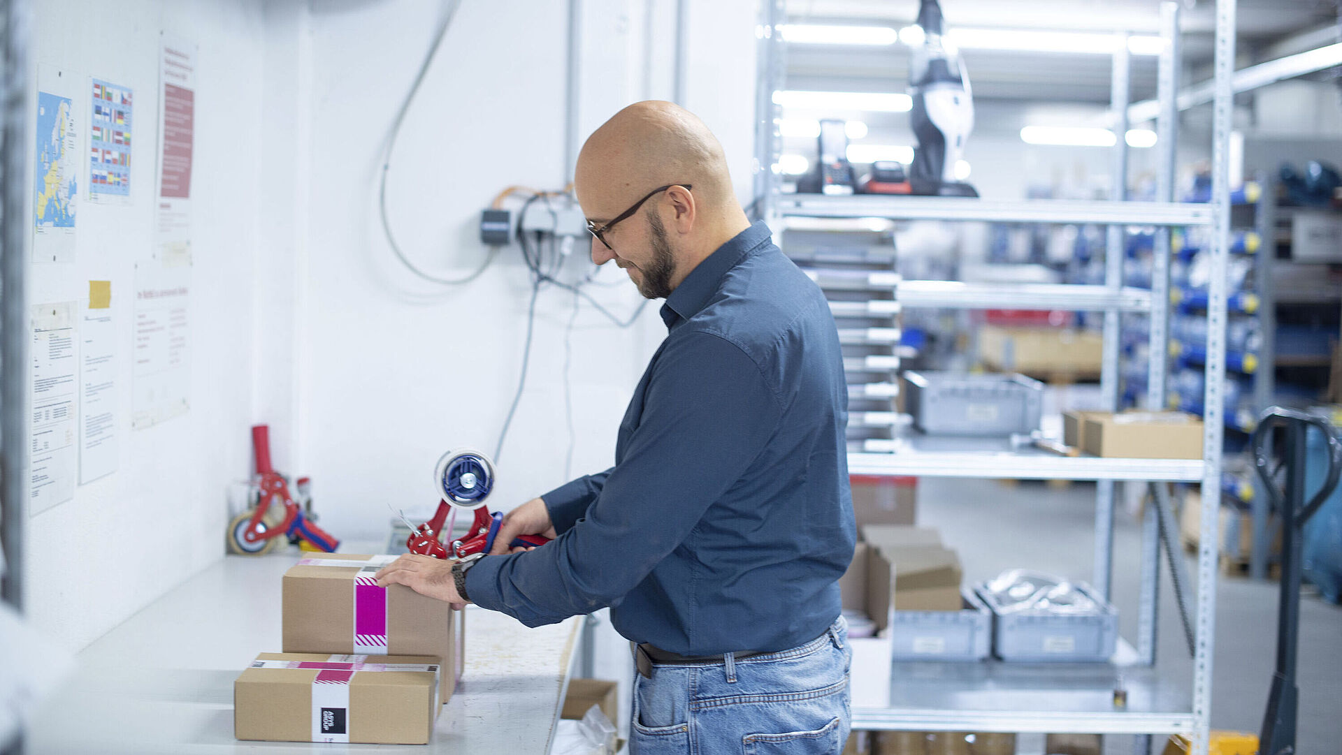Man packing a box in the goods dispatch area
