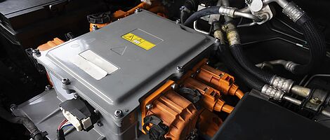 Gray box, which is connected with cables in a hood