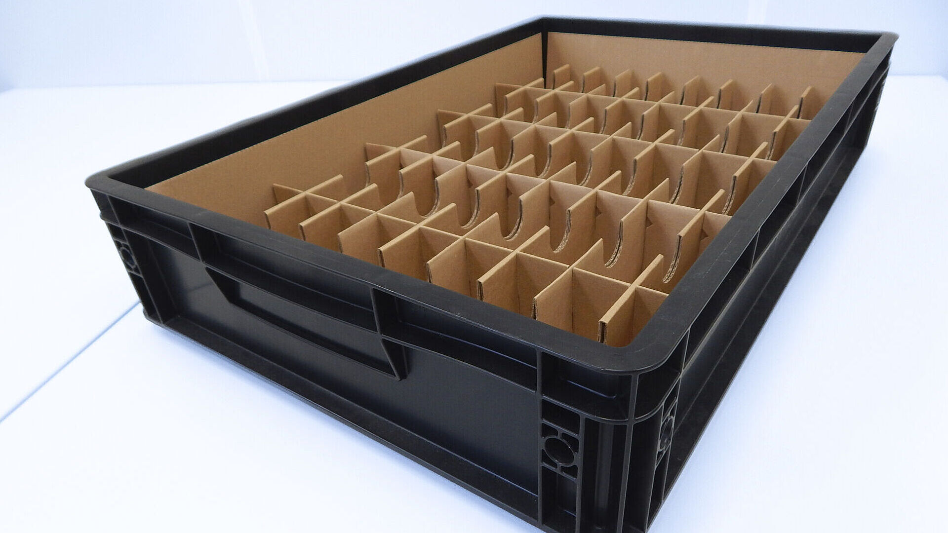 Black plastic box with multiple cardboard compartments, neatly structured and functionally arranged.