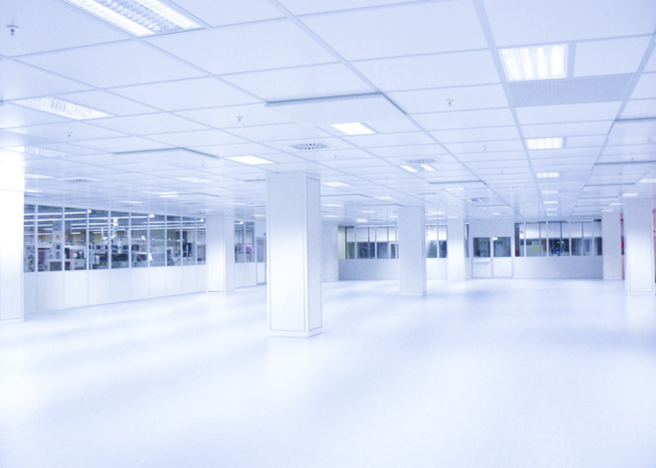 Empty, bright, white room with several columns.