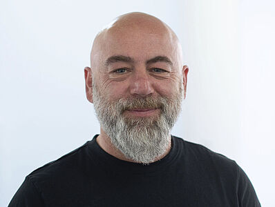 A laughing man in a black T-shirt.
