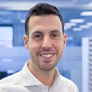 Smiling man in a white shirt in an office