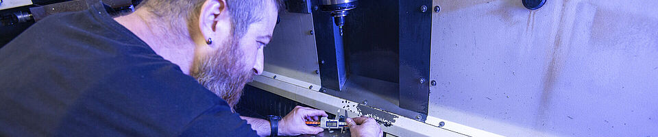 A man is working on a milling machine.