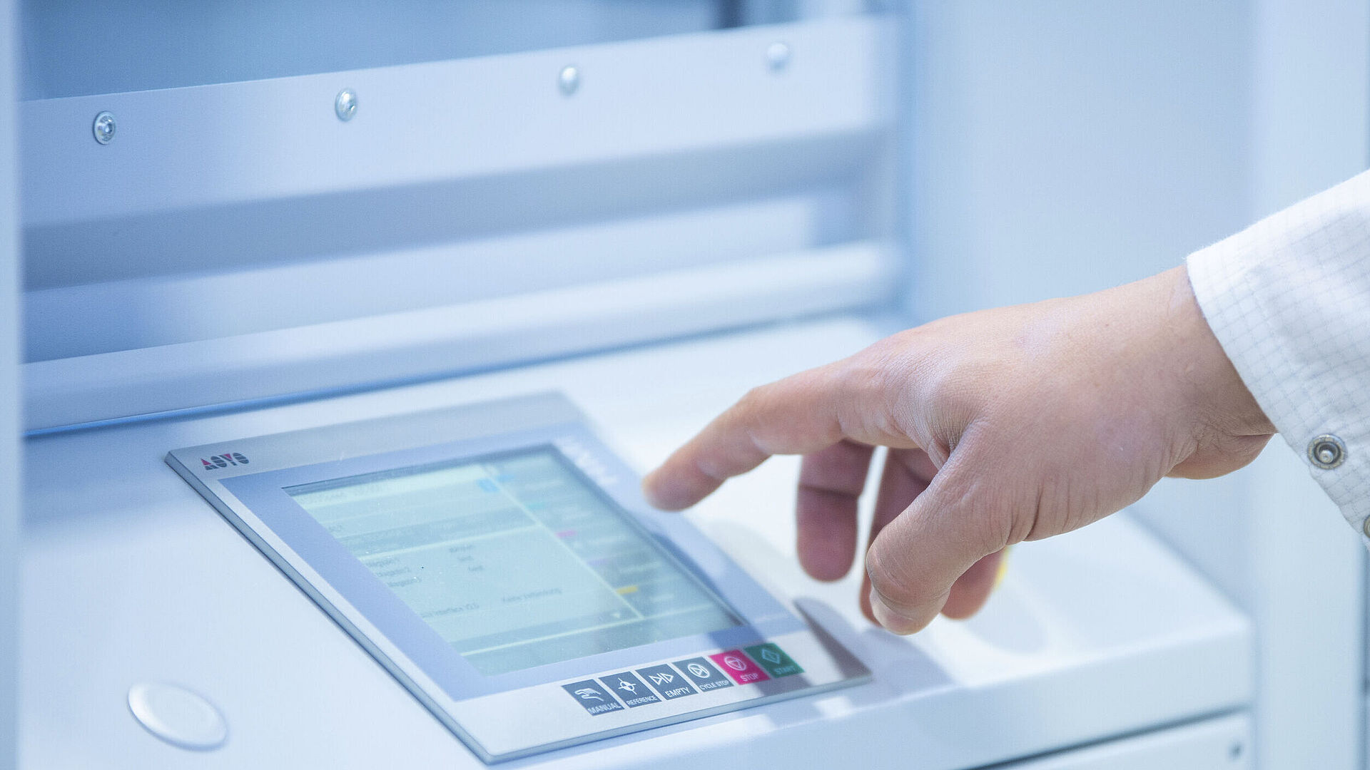 Hand taps on a control panel