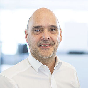 Smiling man in a white shirt.
