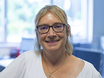A smiling woman in an office.