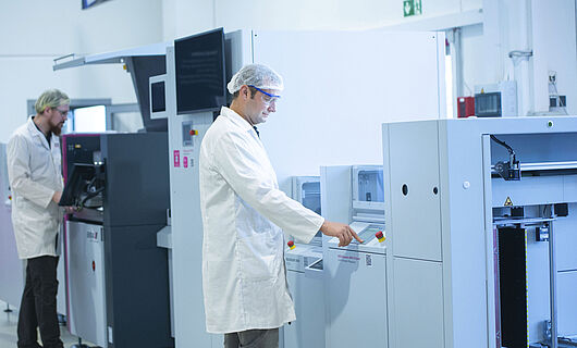 A man installs a machine.