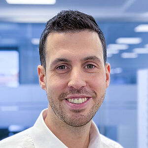 Smiling man in a white shirt in an office