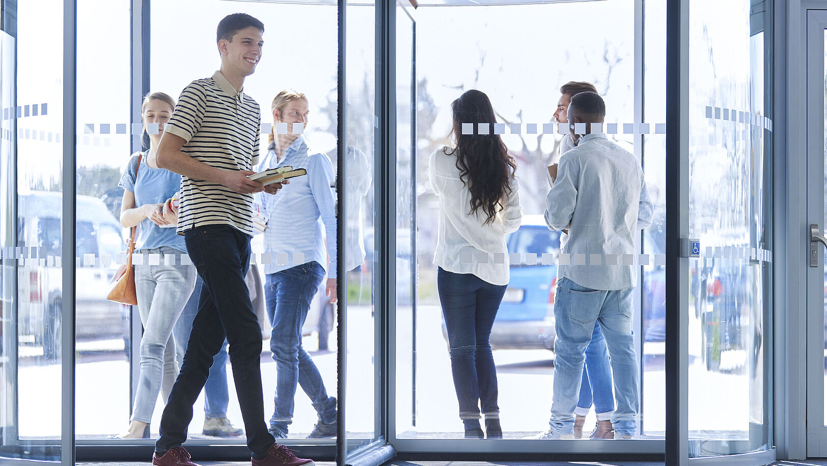 Student walks through a revolving door