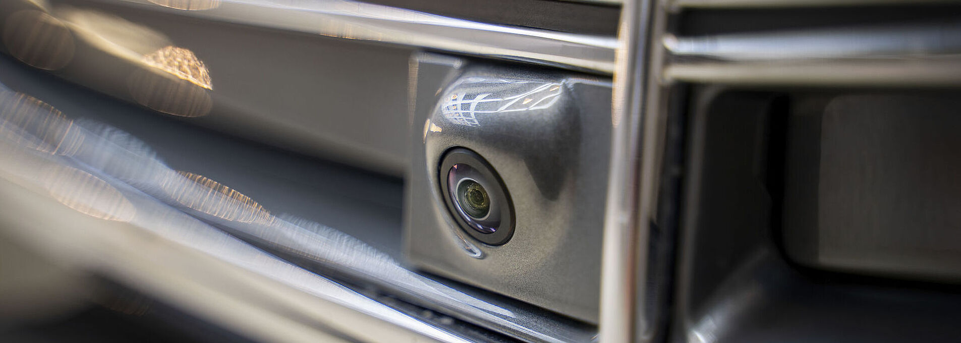 Close-up of the front camera on a metal car.