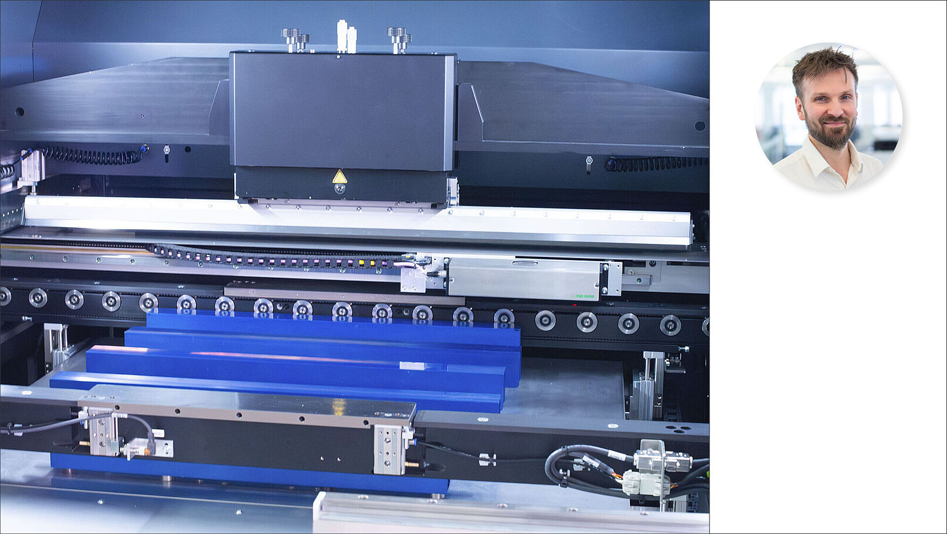 Interior view of a stencil printer with picture of person next to it.