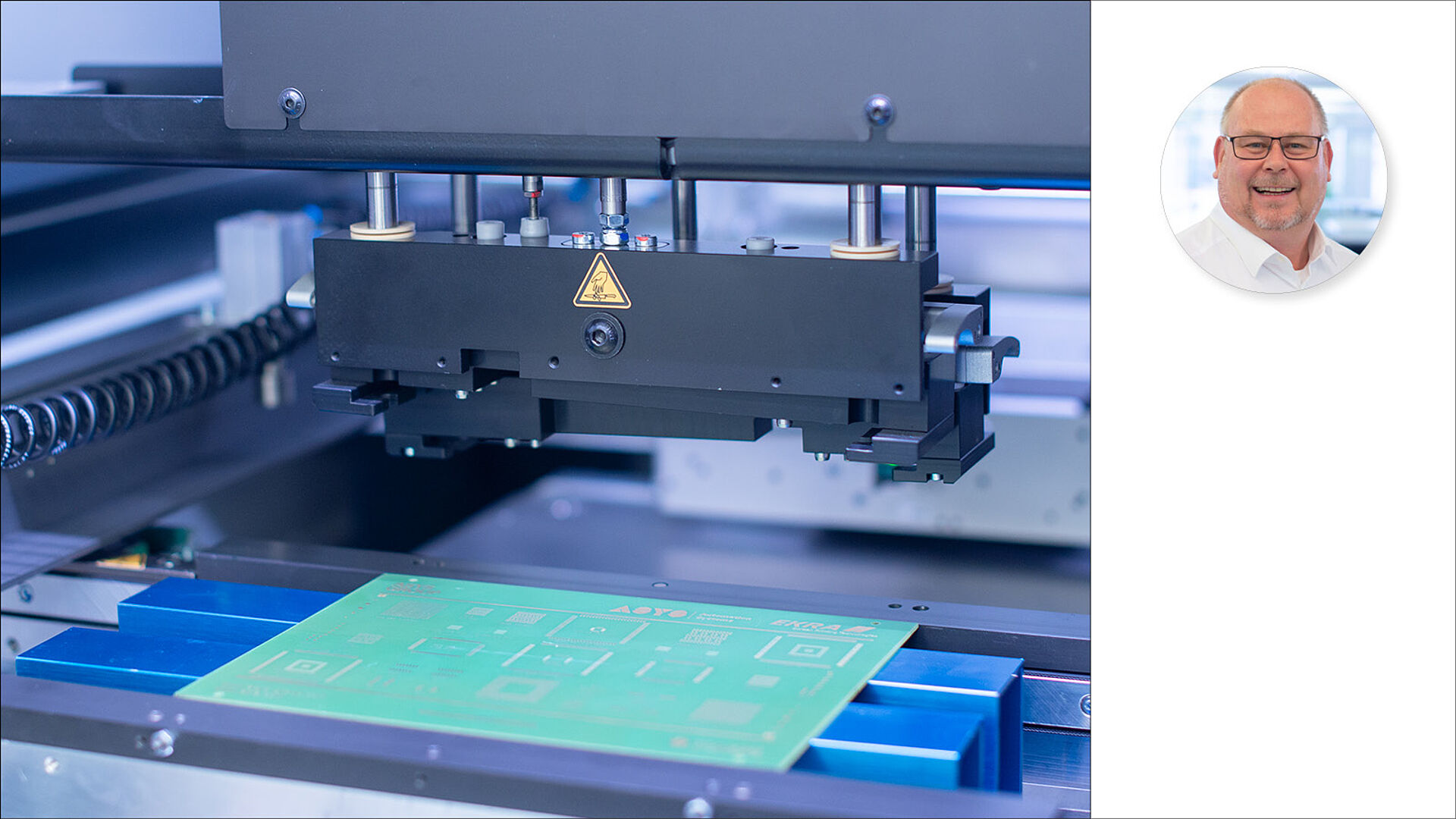Interior view of a stencil printer with a person pictured next to it.