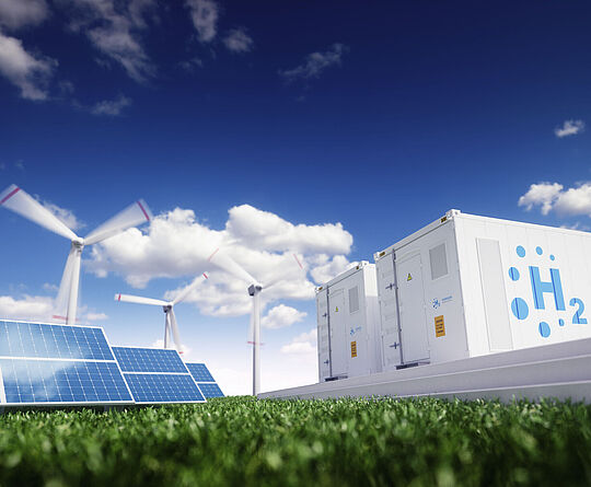 Solar panels, wind turbines, and hydrogen energy storage under blue skies