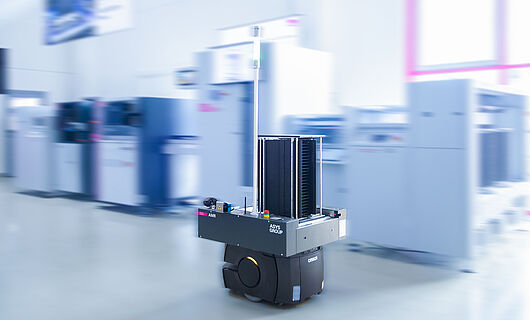 AMR in a demo room in front of a machine line.