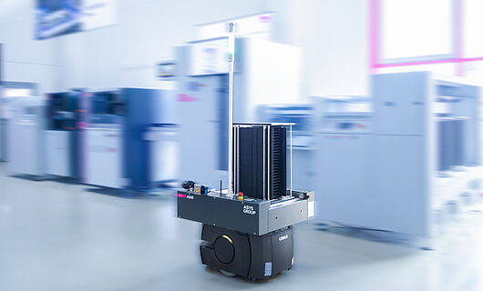 AMR in a demo room in front of a machine line.