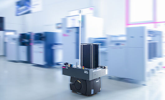 AMR in a demo room in front of a machine line.
