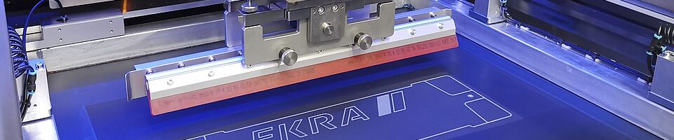 Interior view of a screen printing machine. Squeegee on a surface.