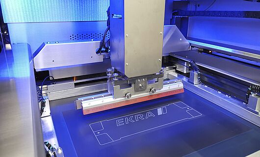 Interior view of a screen printing machine. Squeegee on a surface.