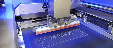 Interior view of a screen printing machine. Squeegee on a surface.
